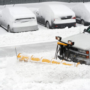 snowplow removing snow on the street after blizzard